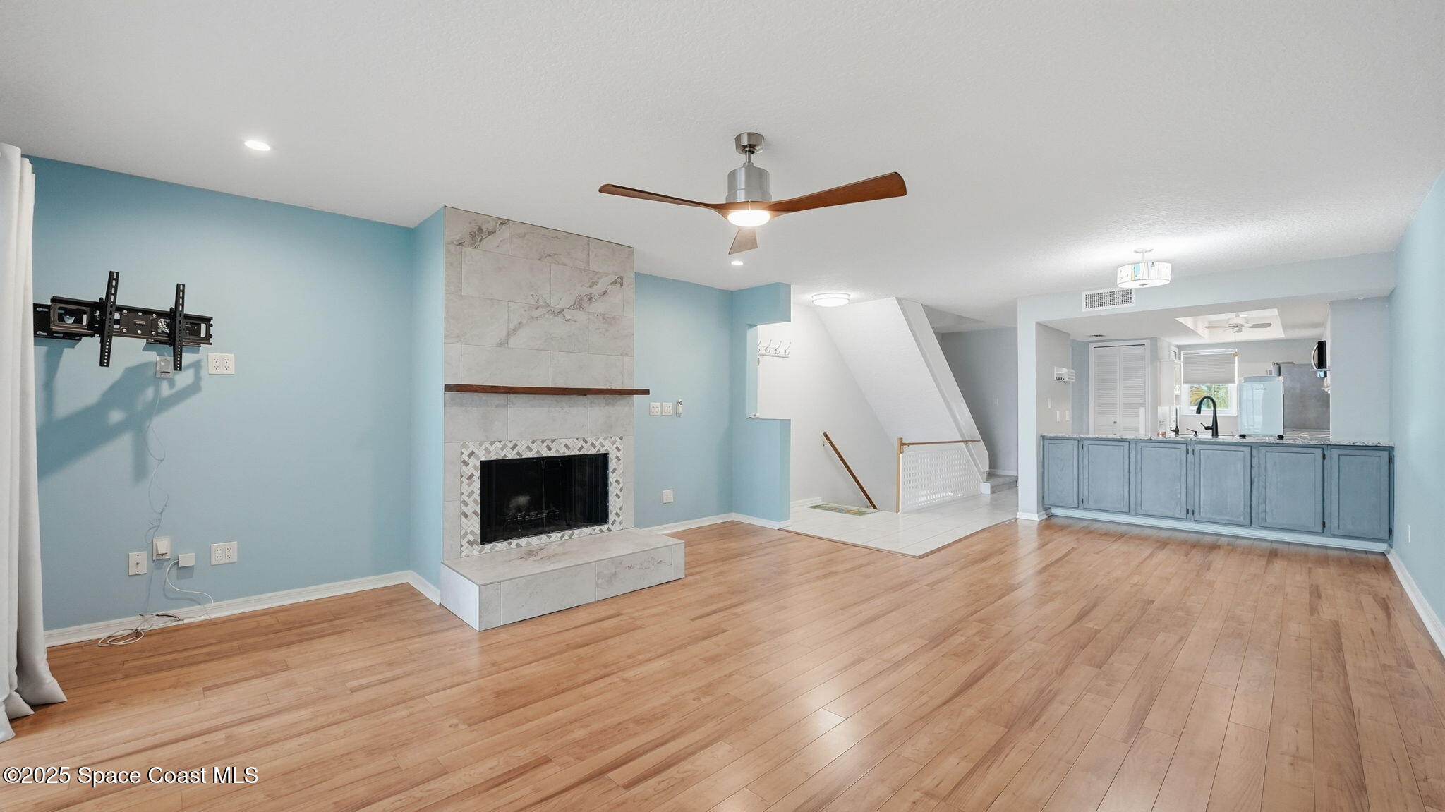 5087 Riveredge Drive, Unit 2 Titusville, FL 32780 - Photo 9 of 62 a view of a livingroom with wooden floor and a fireplace