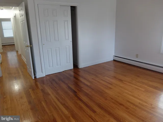 a view of a room with wooden floor