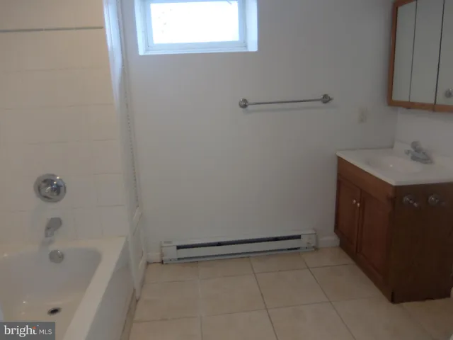 a bathroom with a bathtub sink and vanity
