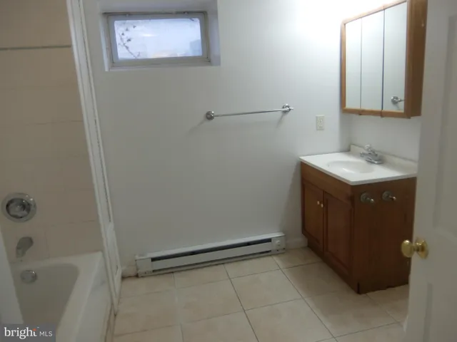 a bathroom with a granite countertop sink a toilet and bathtub