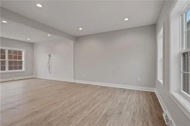 wooden floor in an empty room with a window