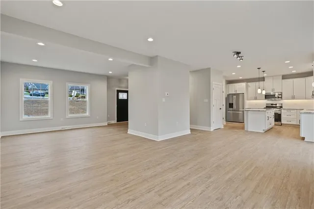 a view of kitchen with wooden floor and windows