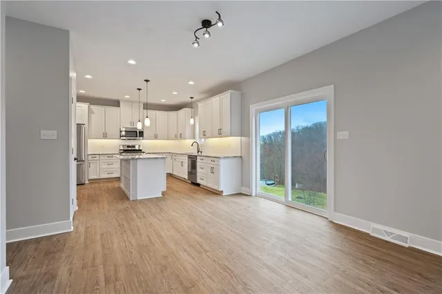 a view of kitchen with wooden floor