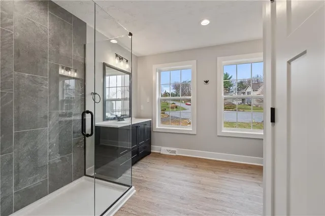 a spacious bathroom with a bathtub and a shower