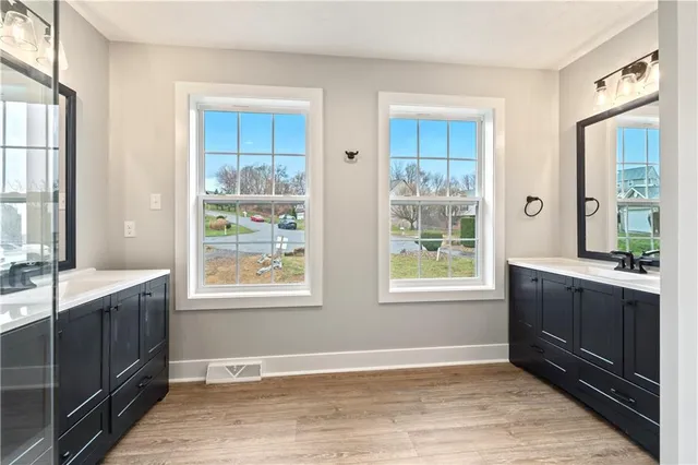 a view of an empty room with window and bathroom