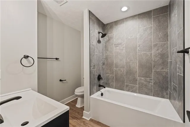 a bathroom with a tub a sink and a shower