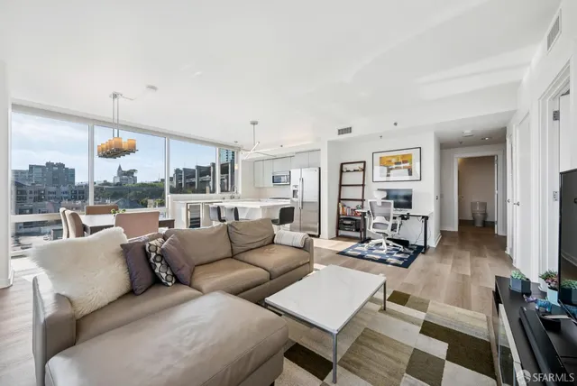 a view of a workspace with furniture and wooden floor