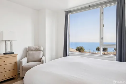 a spacious bedroom with a bed and a couch