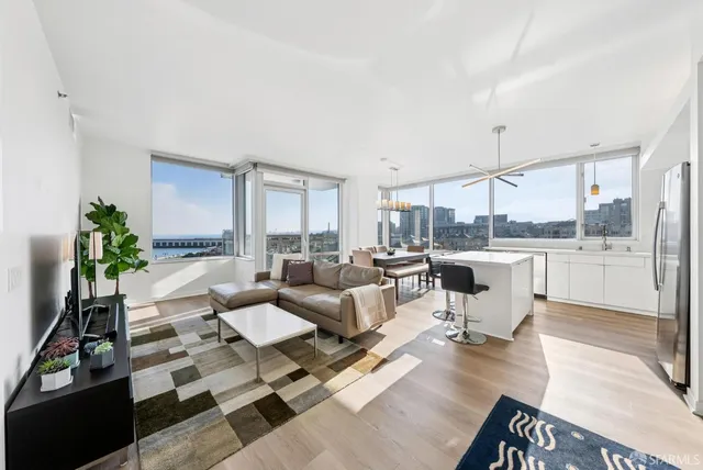 a living room with lots of furniture and a large window