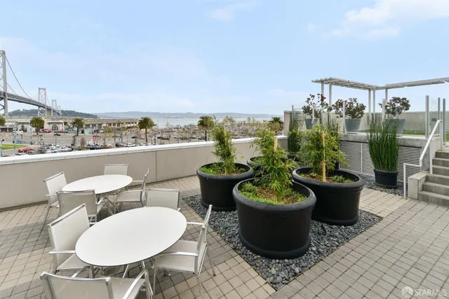 a view of a patio with plants and chairs