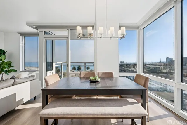 a open kitchen with kitchen island a large window in it