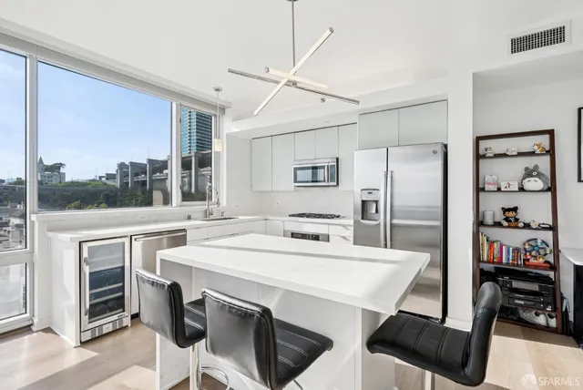 a kitchen with a table chairs stainless steel appliances and cabinets