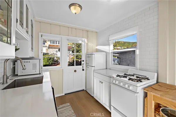 a kitchen with stainless steel appliances granite countertop a stove a refrigerator and a stove