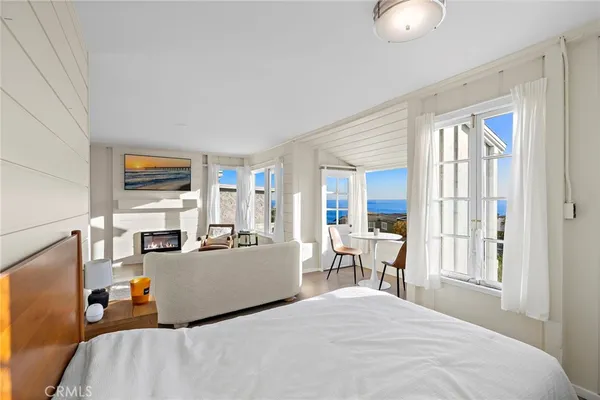 a bed room with a bed and large windows