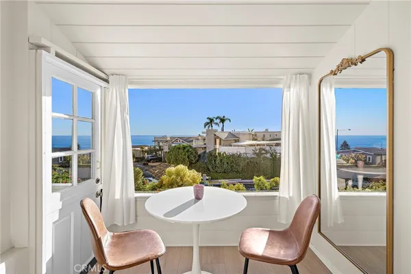 a dining room with furniture and a window