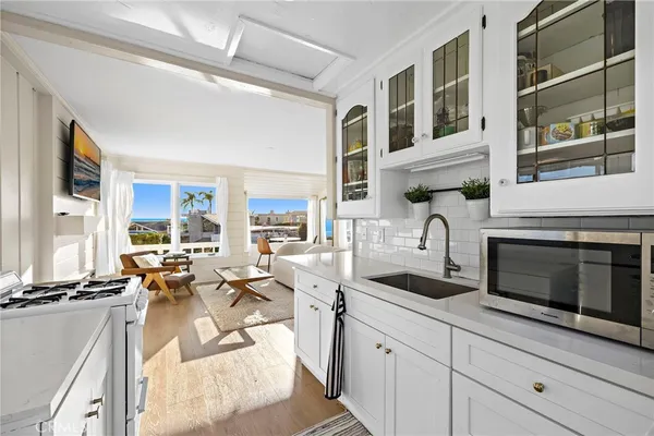 a living room with fireplace furniture and a floor to ceiling window