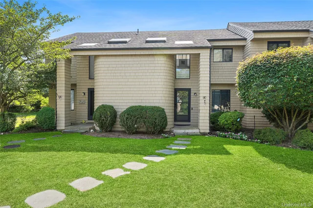 a view of a house with a yard and plants