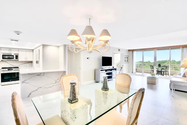 a kitchen with a table chairs and a chandelier