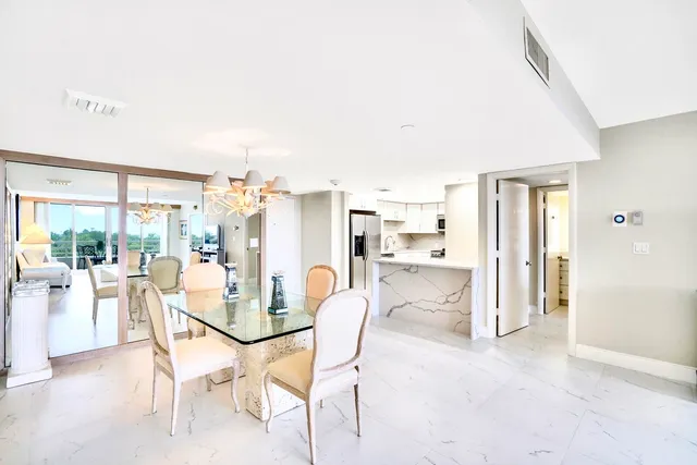 a dining room with furniture and a floor to ceiling window