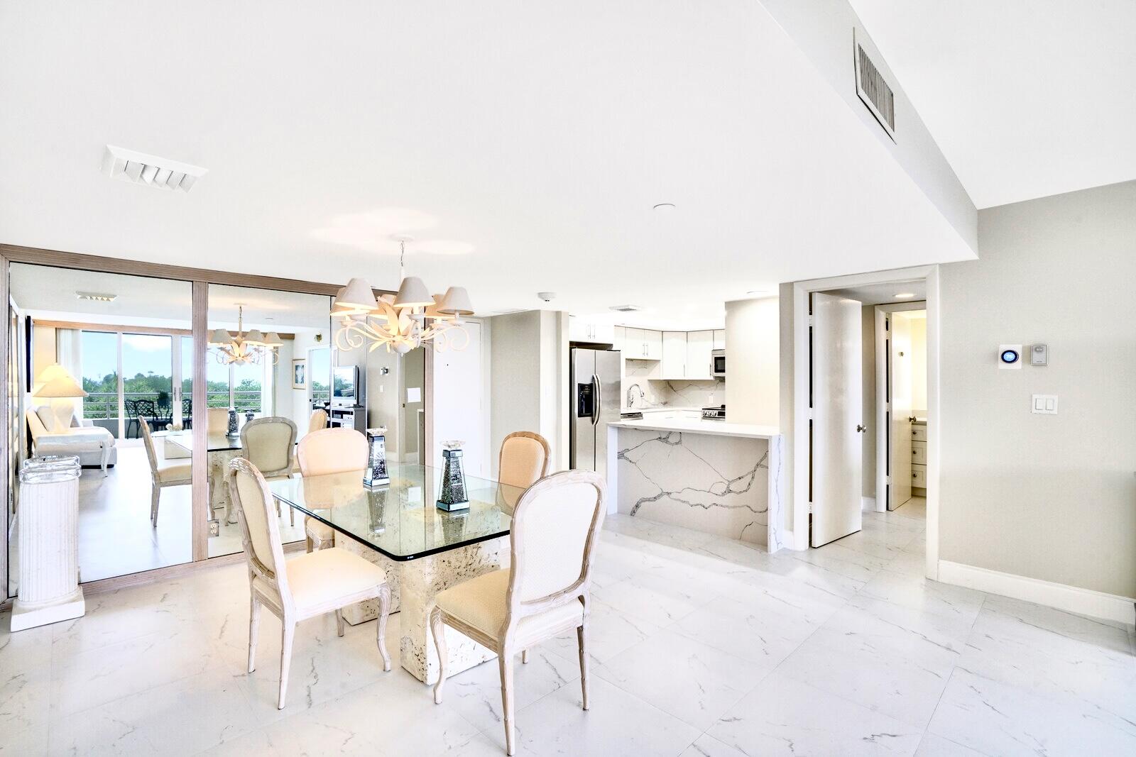4101 North Ocean Boulevard, Unit D408 Boca Raton, FL 33431 - Photo 13 of 31 a dining room with furniture and a floor to ceiling window