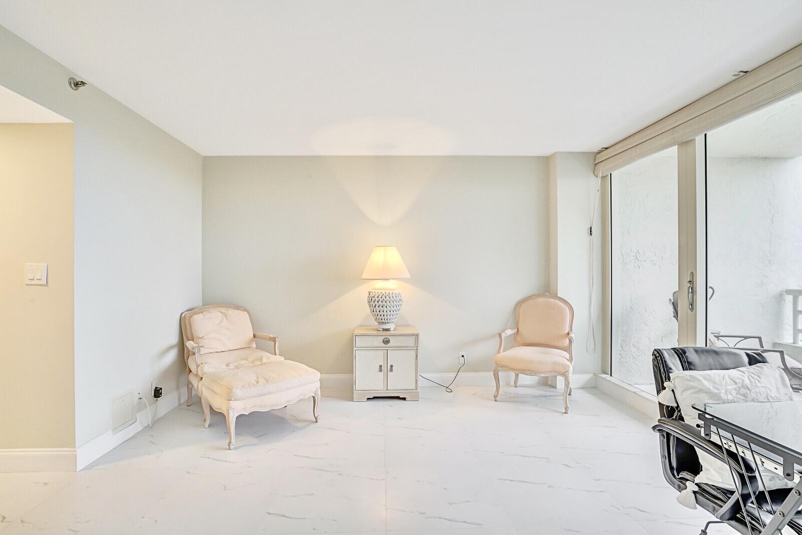 4101 North Ocean Boulevard, Unit D408 Boca Raton, FL 33431 - Photo 26 of 31 a living room with furniture and a chair