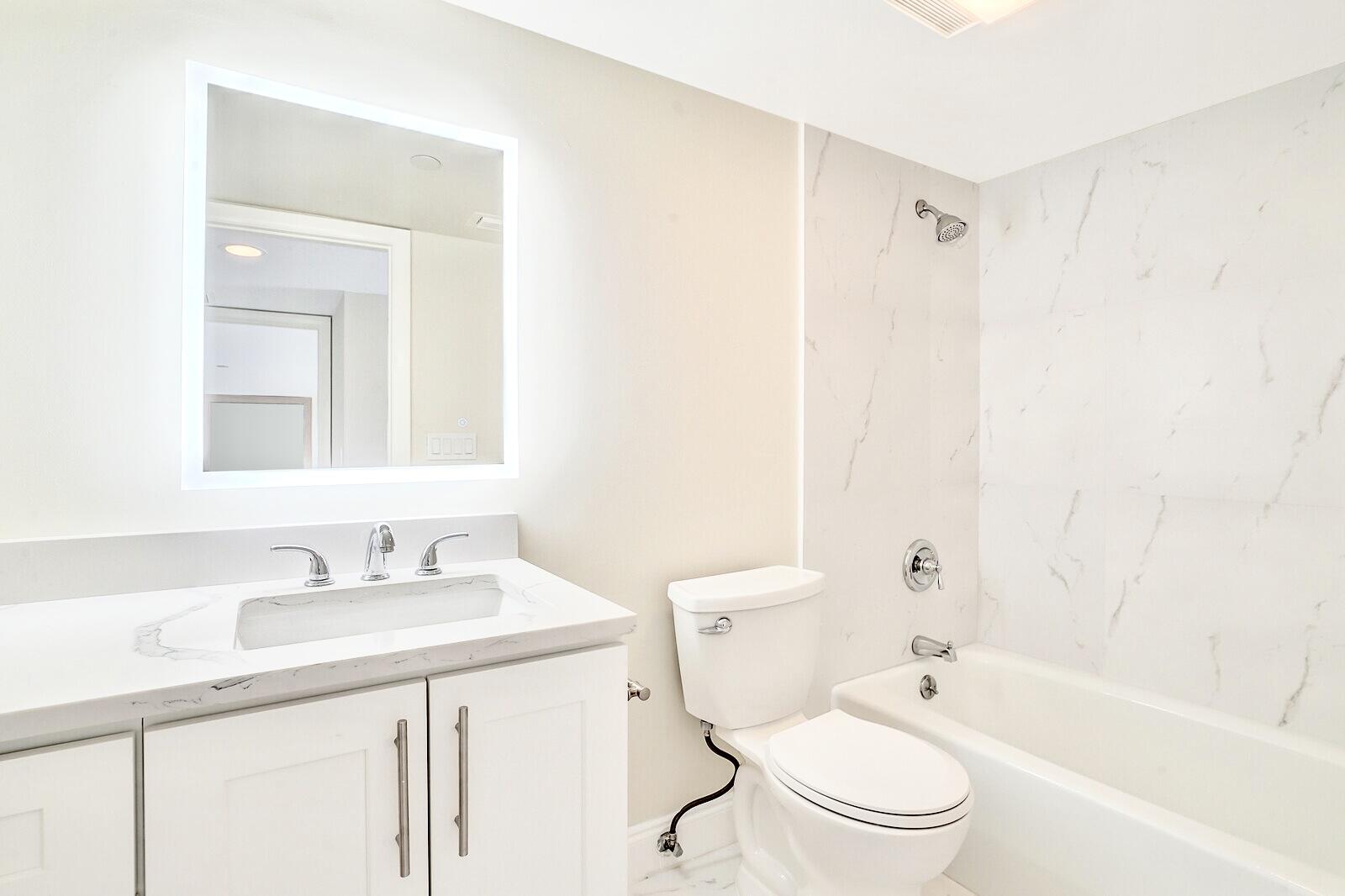 4101 North Ocean Boulevard, Unit D408 Boca Raton, FL 33431 - Photo 28 of 31 a bathroom with a sink a toilet and a bathtub