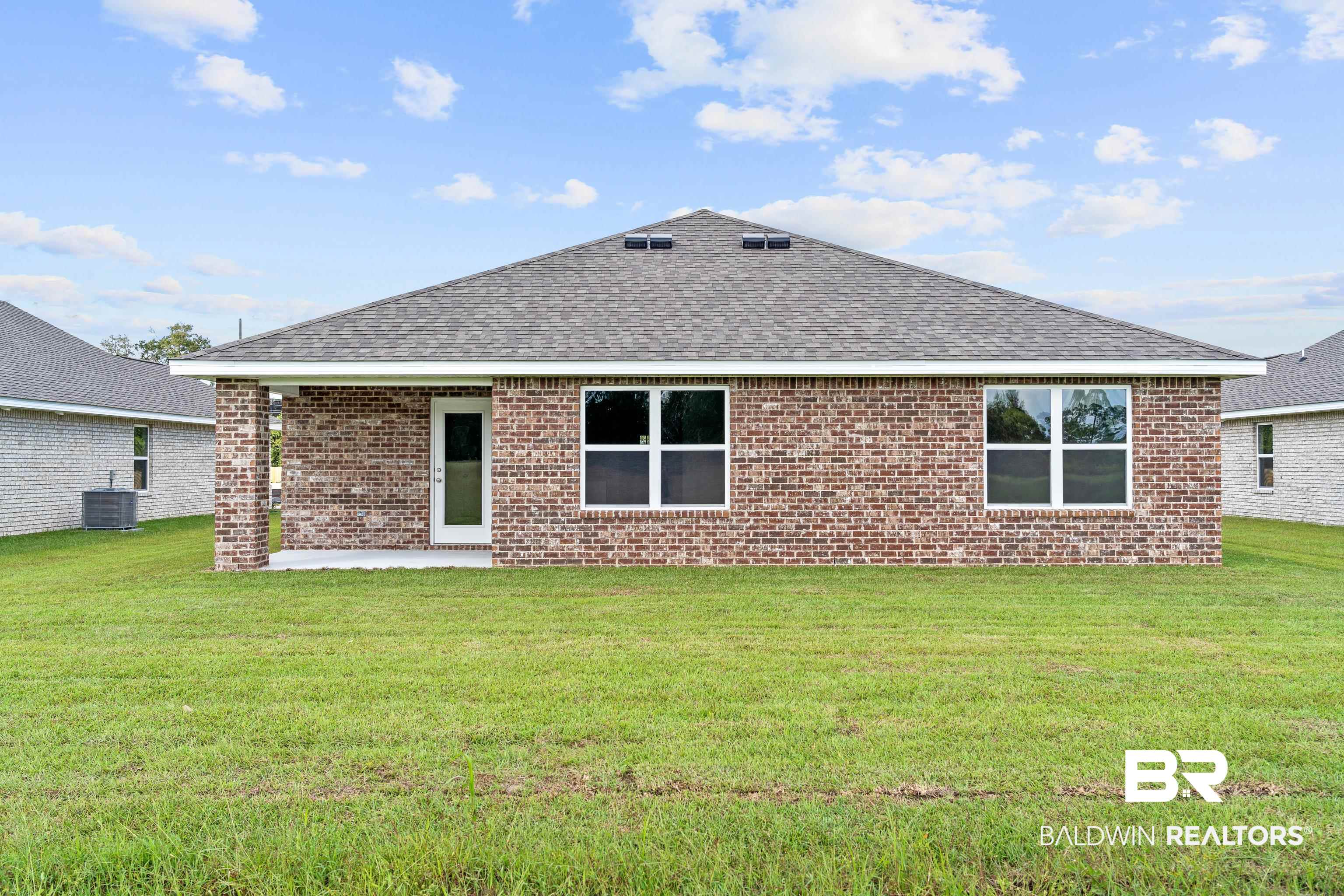 14615 Dayton Circle Foley, AL 36535 - Photo 26 of 27 Red brick exterior featuring a covered patio, multiple windows, and a shingled roof