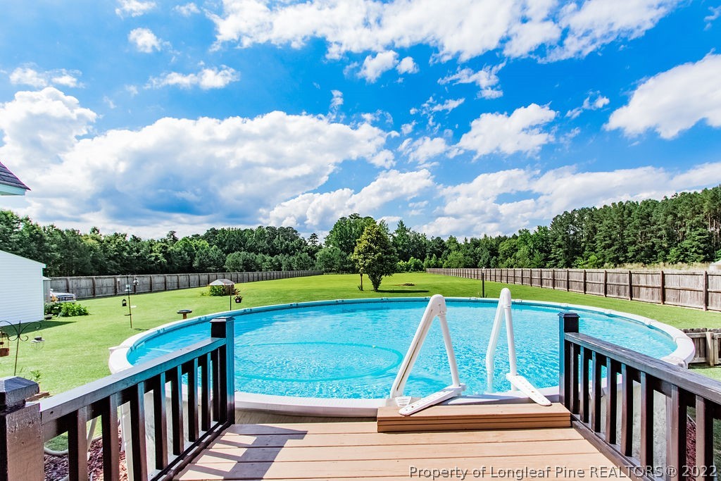 1105 John McMillan Road Hope Mills, NC 28348 - Photo 12 of 50 a view of yard with swimming pool and green space
