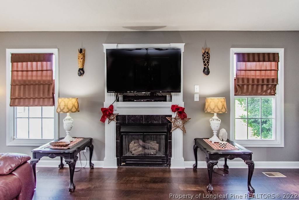 1105 John McMillan Road Hope Mills, NC 28348 - Photo 23 of 50 a living room with furniture a flat screen tv and a fireplace