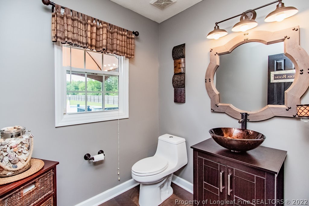 1105 John McMillan Road Hope Mills, NC 28348 - Photo 25 of 50 a bathroom with a toilet and a sink