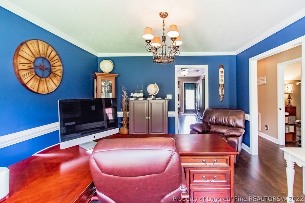 1105 John McMillan Road Hope Mills, NC 28348 - Photo 27 of 50 a living room with furniture a fireplace and a chandelier
