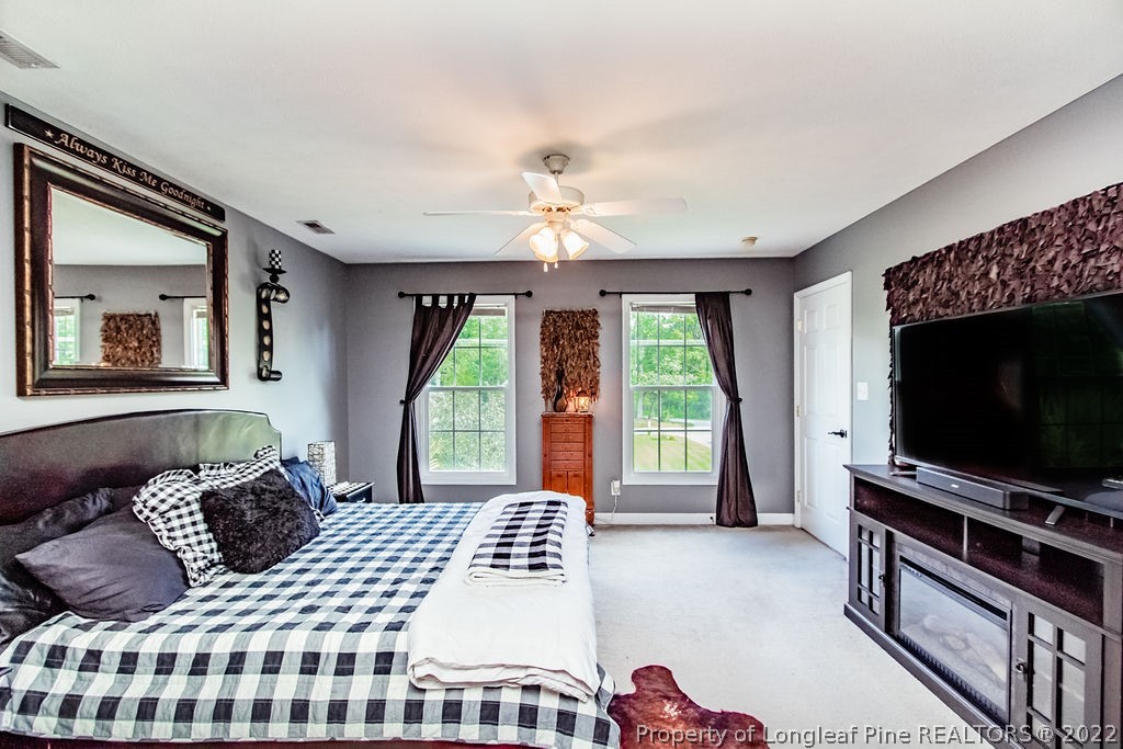 1105 John McMillan Road Hope Mills, NC 28348 - Photo 30 of 50 a bedroom with a bed and a flat screen tv