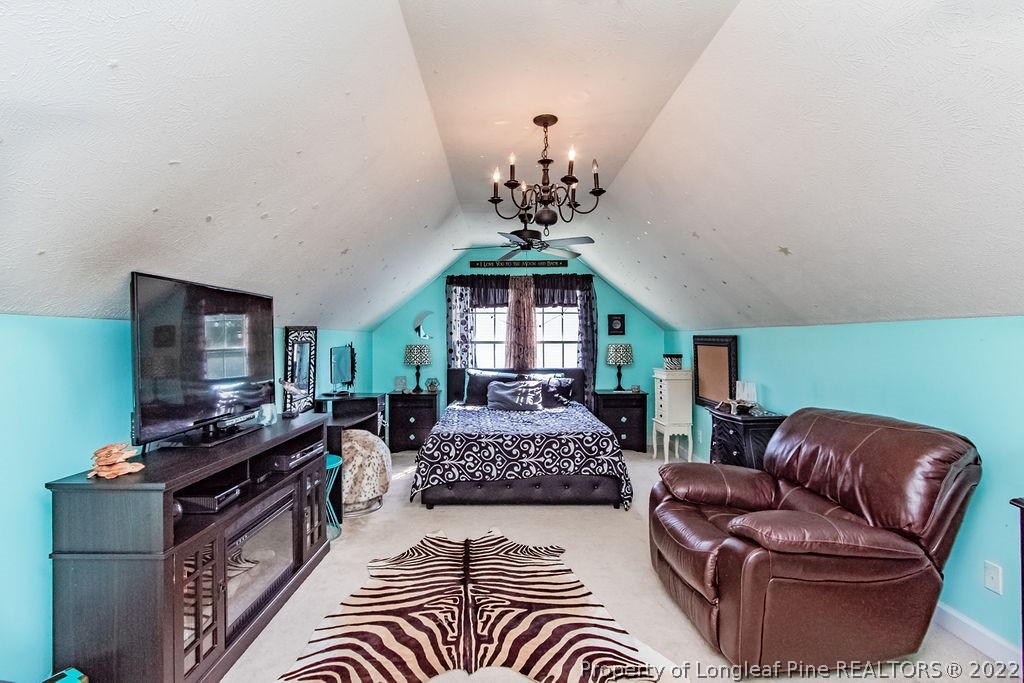 1105 John McMillan Road Hope Mills, NC 28348 - Photo 34 of 50 a living room with furniture and a chandelier