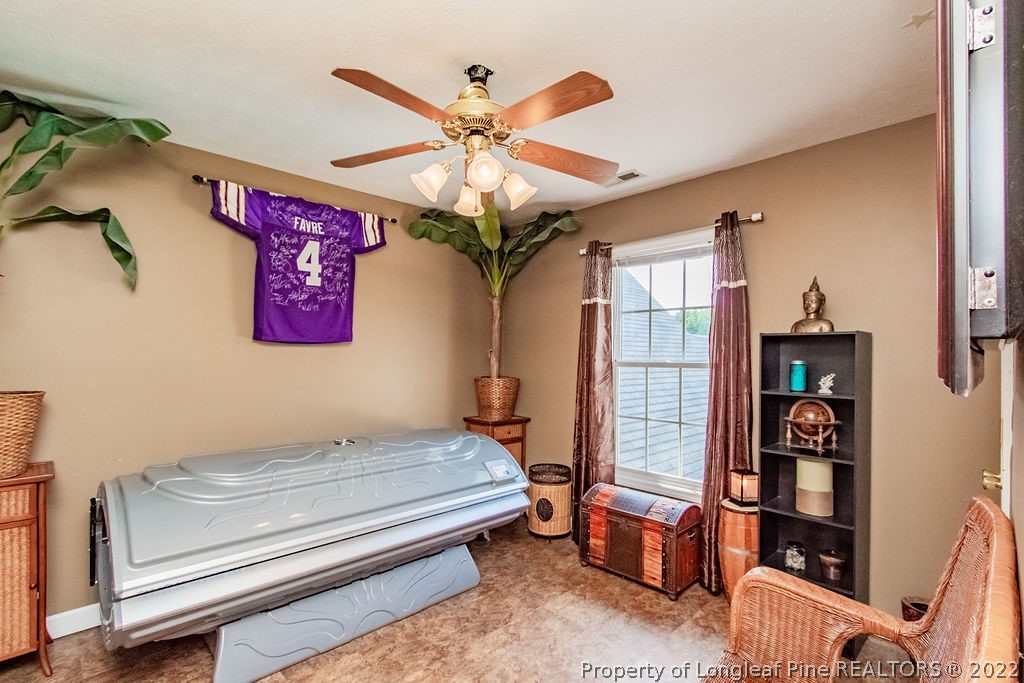 1105 John McMillan Road Hope Mills, NC 28348 - Photo 38 of 50 a bedroom with furniture and a chandelier