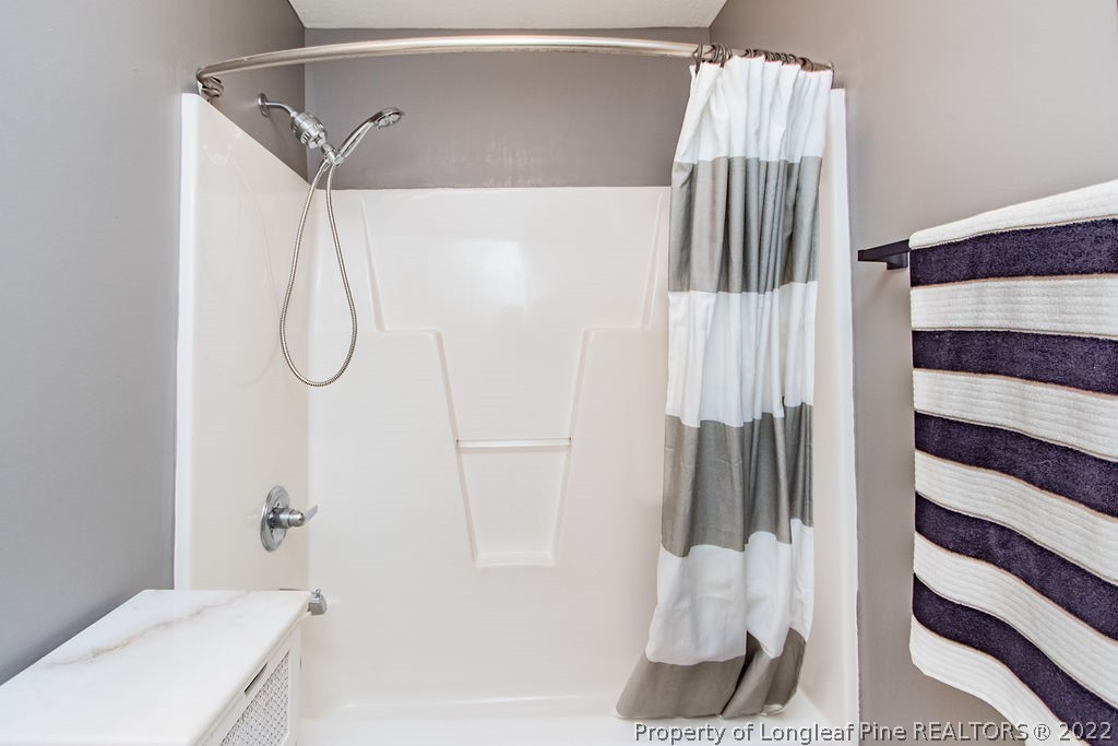 1105 John McMillan Road Hope Mills, NC 28348 - Photo 39 of 50 a bathroom with a sink and a shower curtain