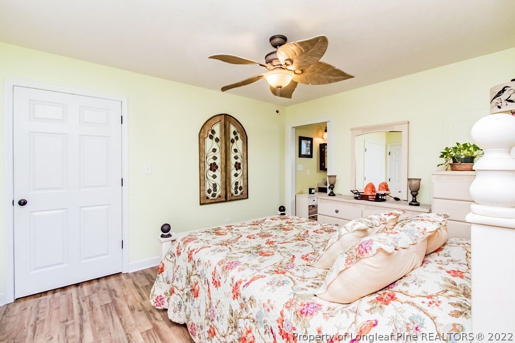 1105 John McMillan Road Hope Mills, NC 28348 - Photo 41 of 50 a bedroom with a bed and a chandelier