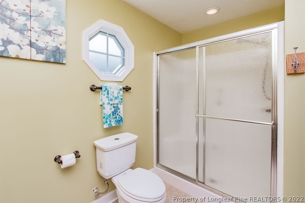 1105 John McMillan Road Hope Mills, NC 28348 - Photo 43 of 50 a white toilet sitting next to a bathroom sink