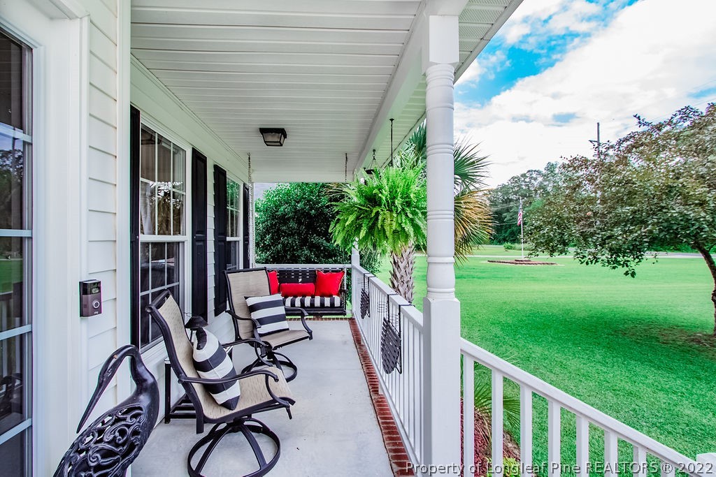 1105 John McMillan Road Hope Mills, NC 28348 - Photo 5 of 50 a view of a porch with wooden floor and outdoor seating