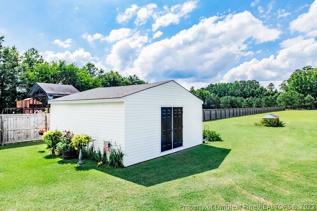 1105 John McMillan Road Hope Mills, NC 28348 - Photo 7 of 50 a view of a backyard with potted plants and large tree