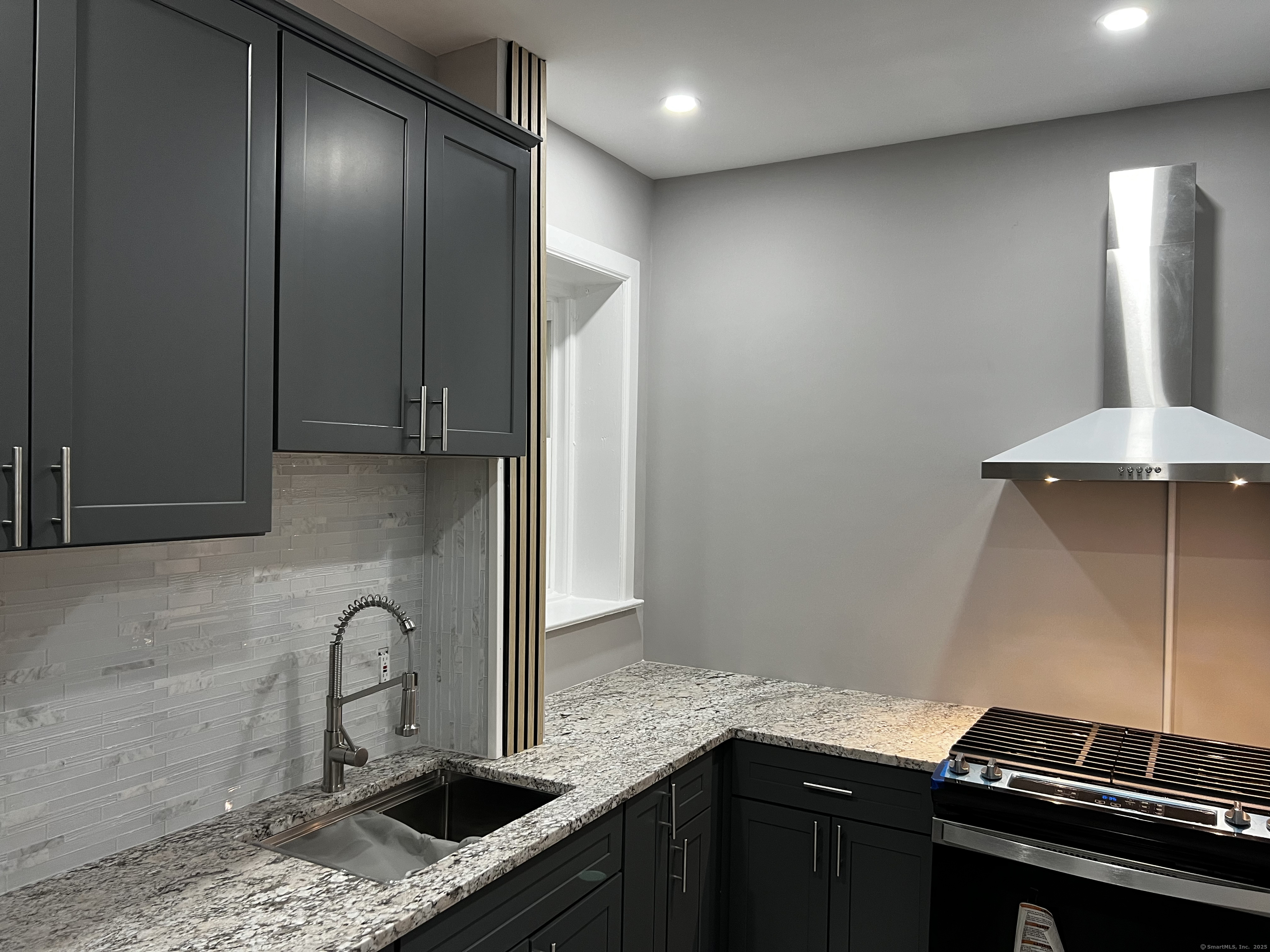 59 Rennell Street, Unit 19 Bridgeport, CT 06604 - Photo 3 of 7 a kitchen with stainless steel appliances granite countertop a sink and cabinets