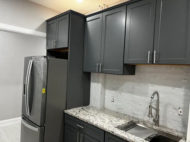 a kitchen with stainless steel appliances granite countertop a refrigerator and a sink
