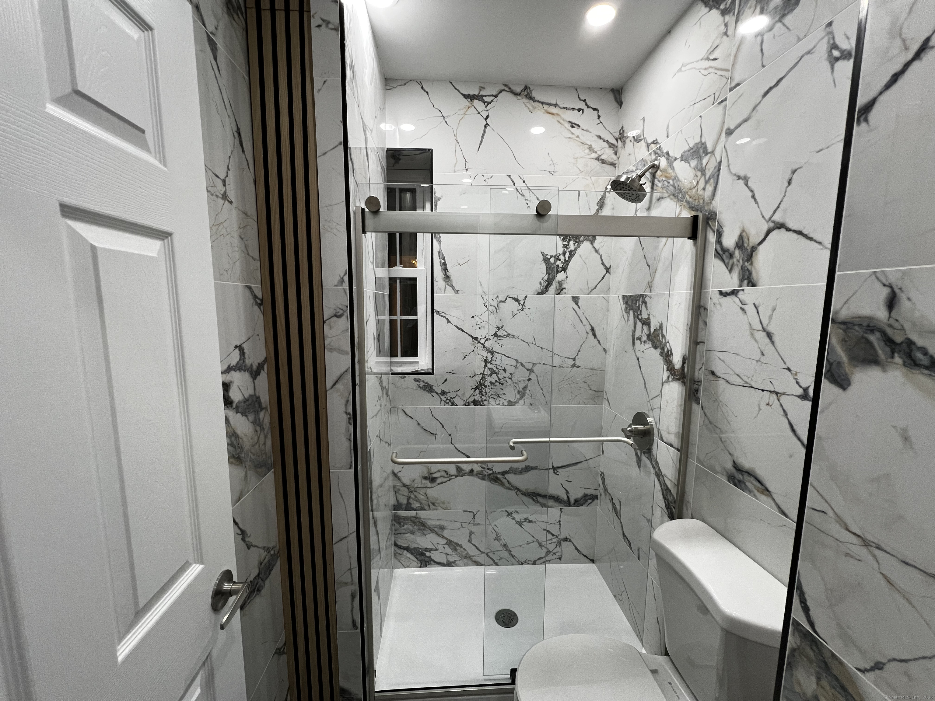 59 Rennell Street, Unit 19 Bridgeport, CT 06604 - Photo 5 of 7 a bathroom with a bathtub and toilet