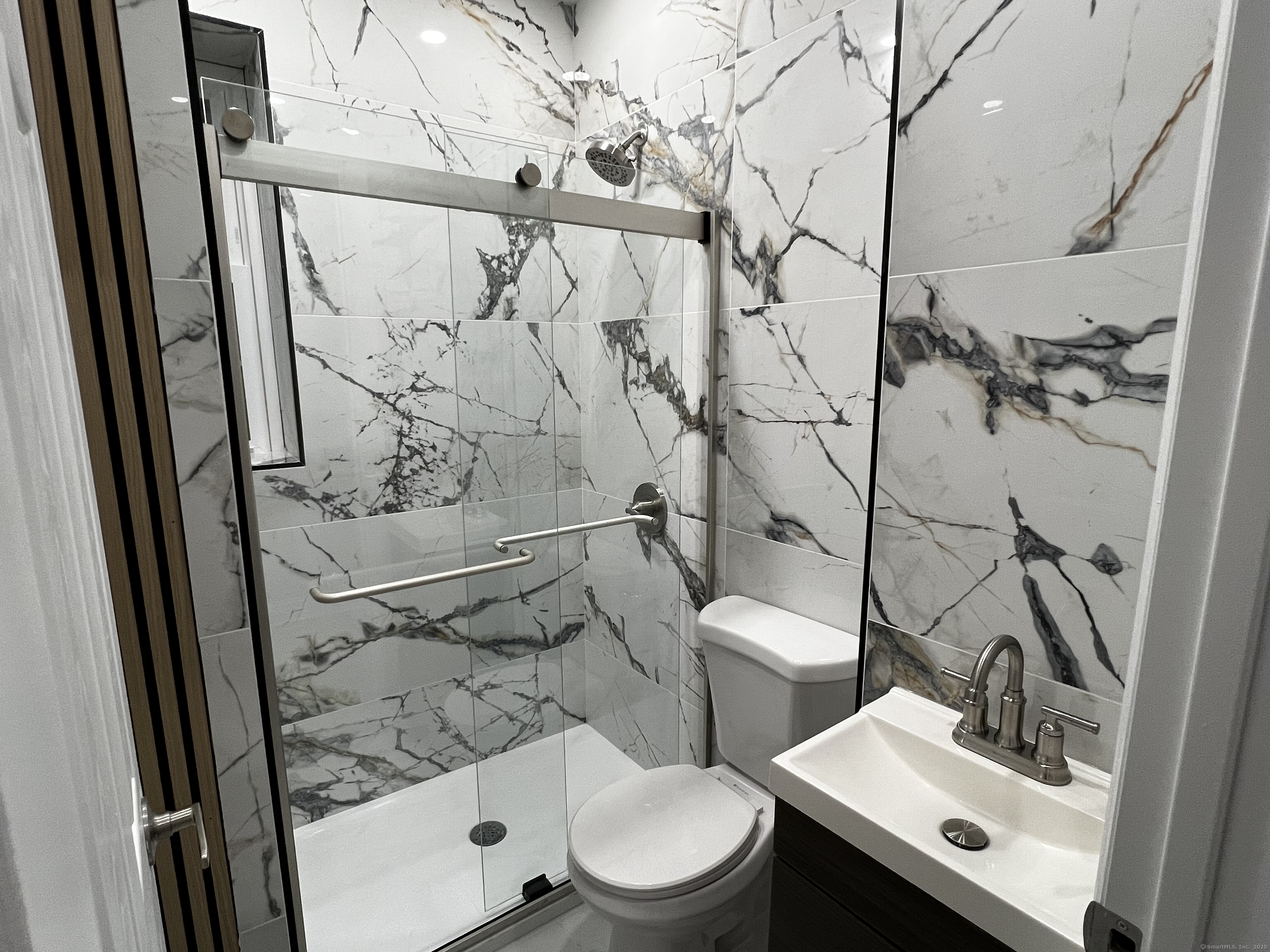 59 Rennell Street, Unit 19 Bridgeport, CT 06604 - Photo 6 of 7 a bathroom with a toilet sink and shower