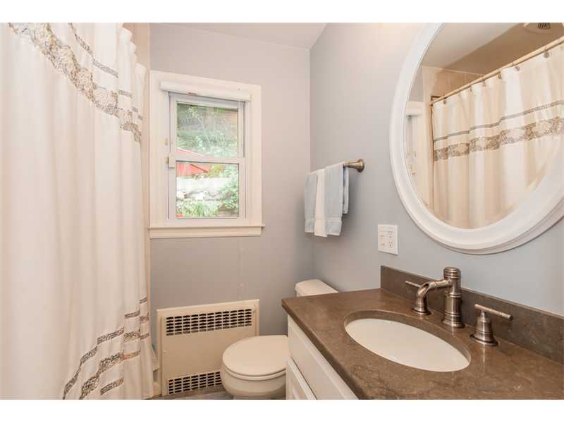 3 Green Lane Greenwich, CT 06831 - Photo 9 of 20 a bathroom with a sink a mirror a toilet and a window