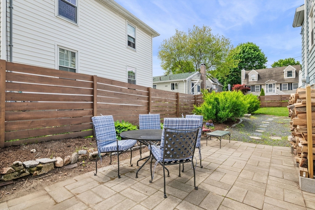 8 Baker Avenue Beverly, MA 01915 - Photo 29 of 40 a view of a patio with table and chairs and potted plants
