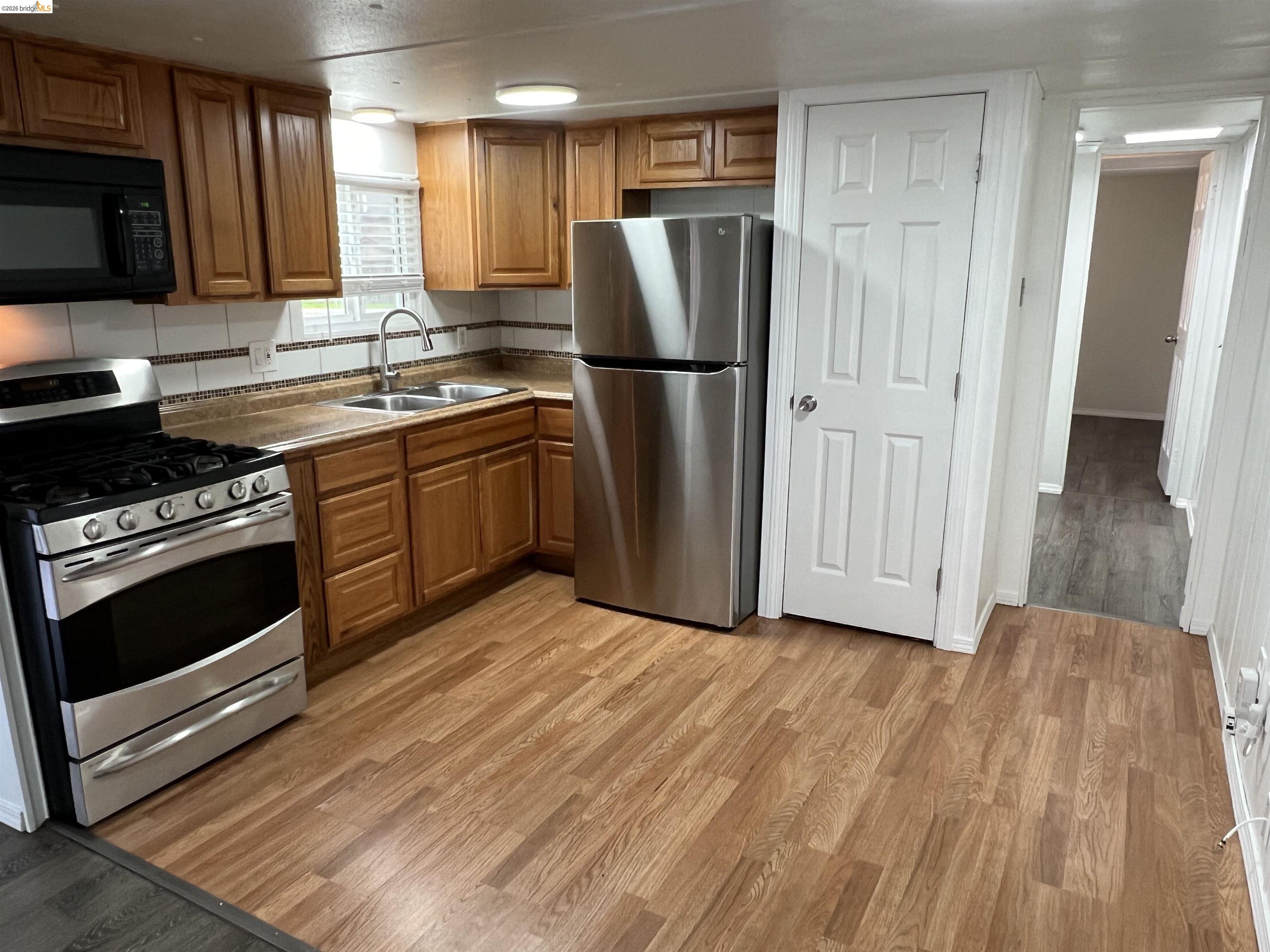 210 West Cypress Road, Unit 1 Oakley, CA 94561 - Photo 8 of 26 a kitchen with a refrigerator stove and wooden cabinets