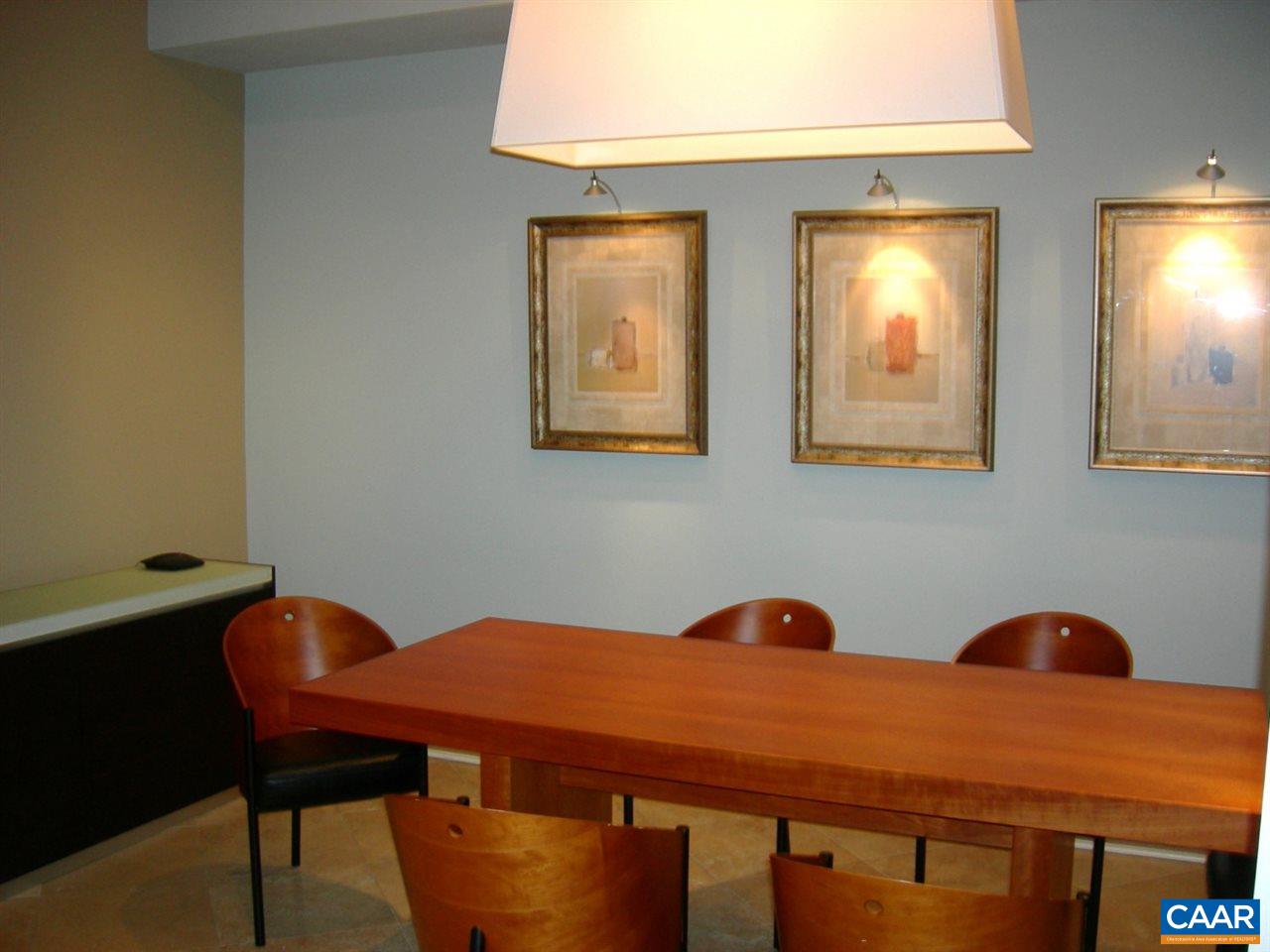 775 Walker Square, Unit 3C Charlottesville, VA 22903 - Photo 13 of 17 a blue kitchen with a table and chairs