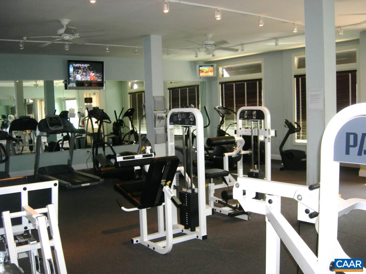 775 Walker Square, Unit 3C Charlottesville, VA 22903 - Photo 14 of 17 a room with gym equipment and large mirror
