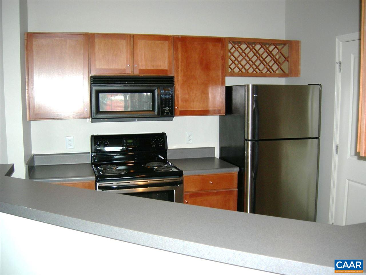 775 Walker Square, Unit 3C Charlottesville, VA 22903 - Photo 3 of 17 a kitchen with stainless steel appliances a refrigerator and a stove top oven