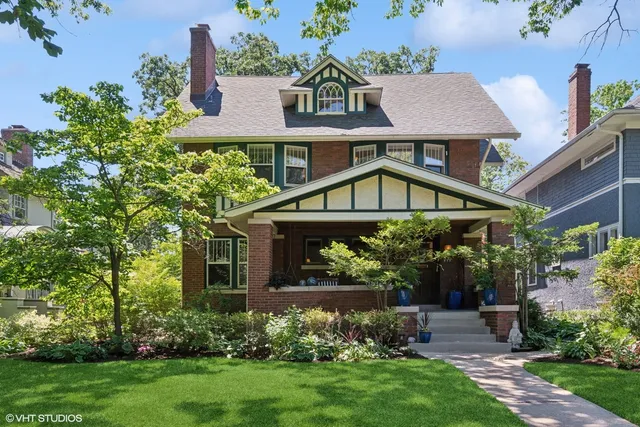 a view of house with garden and a tree